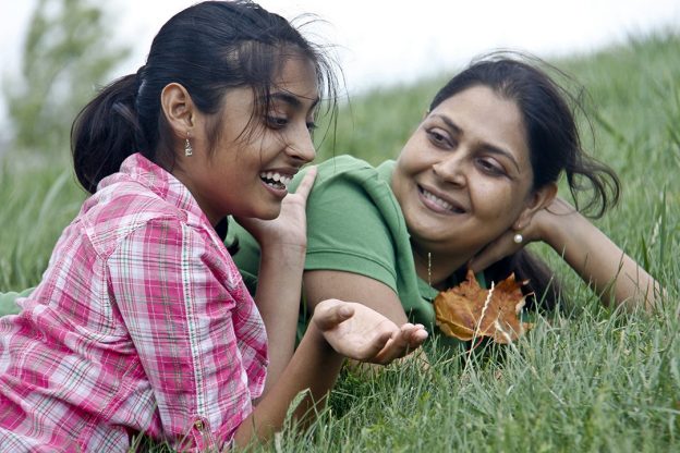 teen and parent talking in happy mood